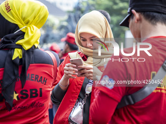 Jakarta, 01 May 2019 : A beautifull hijab Labor during the demonstration. Thousands of Labor filled Merdeka Barat Street Jakarta celebrating...