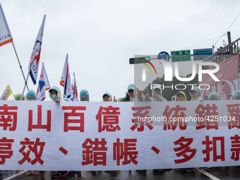 Protesters marching with banners and flags calling for more holidays, paid leave, more labour rights protections. During 2019 Labor Day Marc...
