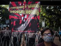 Indonesian worker holds placard during May Day rally in Jakarta on May 1, 2019.  Thousands of Indonesian workers are urging the government t...