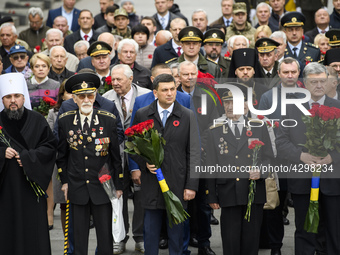 Ukrainian President Petro Poroshenko (L)  and Prime Minister Volodymyr Groysman (C)  attends ceremony of laying flowers during Victory Day c...