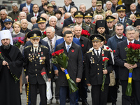 Ukrainian President Petro Poroshenko (L)  and Prime Minister Volodymyr Groysman (C)  attends ceremony of laying flowers during Victory Day c...