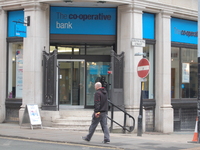 A person walking past a branch of the Co-Operative Bank in central Manchester on Tuesday 10th February 2015. -- The Co-Operative Bank has st...