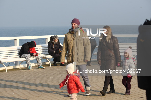 Gdynia, Poland 14th, Feb. 2015 People enjoy sunny and warm weather walking along the Baltic Sea coast and Orlowo Pier in Gdynia Orlowo. Mete...