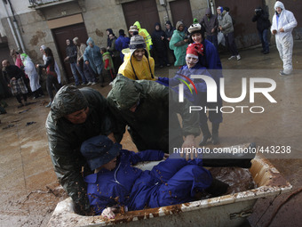 People enjoy during the 'Farrapada' (Battle of mud) in the 'Entroido' carnival festivity in Laza, Galicia northwestern Spain on February 16,...
