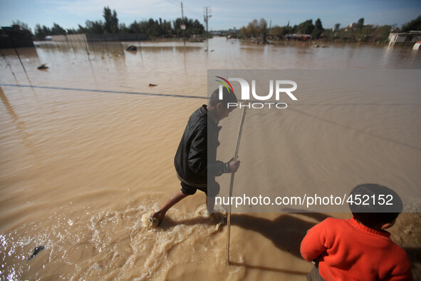 Palestinians Bedouin walks through muddy waters after heavy rains which flooded the Al Moghraka area in the central Gaza Strip. Israeli auth...