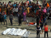 BANGLADESH, Paturia : Bangladesh officials and bystanders gather alongside bodies recovered by rescue workers following a ferry accident at...