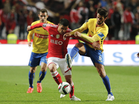 Benfica's defender Maxi Pereira (L) vies for the ball with Estoril's midfielder Afonso Taira (R)  during the Portuguese League  football mat...