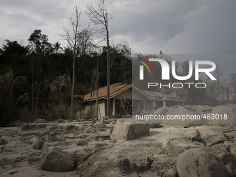 This photo was taken on February 28, 2015 shows a house collapsed due to the eruption of Mount Sinabung (not in picture) in the abandoned vi...