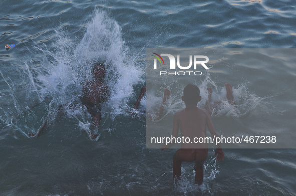 Four young boys dives into the waters at a public beach on 3rd March 2015 in Lapu Lapu City, Cebu, Philippines. With classes about to end an...