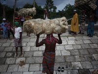 Labourers carry jute from a boat to a truck to send it in the capital Dhaka. Photo has taken on 26 July 2019 from Kurigram, Bangladesh.  (