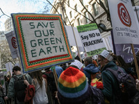Demonstrators display placards and banners during The People's Climate march in central London on March 7, 2015. Around 5,000 protesters mar...