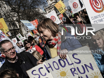 Demonstrators display placards and banners during The People's Climate march in central London on March 7, 2015. Around 5,000 protesters mar...
