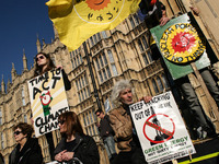 Demonstrators display placards and banners as they listen to a speech in front of the Houses of Parliament during The People's Climate march...