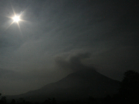In this photo taken on March 7, 2015, A shining star shaped moon with clouds Sinabung hot lead into the air after this latest eruption in Ka...
