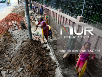 Bangladeshi men and women day laborer works in a road construction site in Dhaka, Bangladesh, on September 7, 2019. (