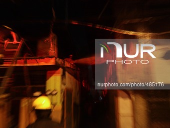 Makati City, Philippines - Firemen rush to extinguish remaining fire in a residential area in Barangay San Antonio, Makati City on Saturday...