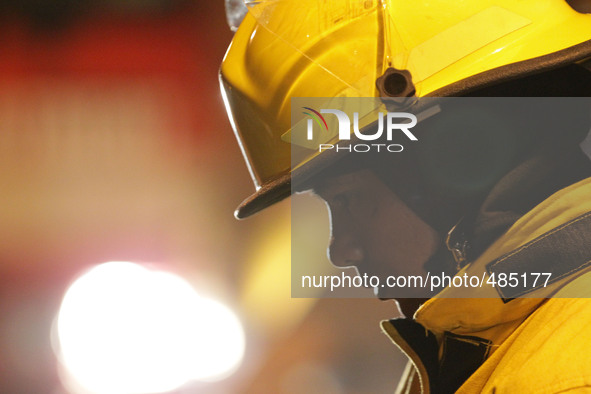 Makati City, Philippines - A Fireman looks on after a fire hit a residential area in Barangay San Antonio, Makati City on Saturday evening,...