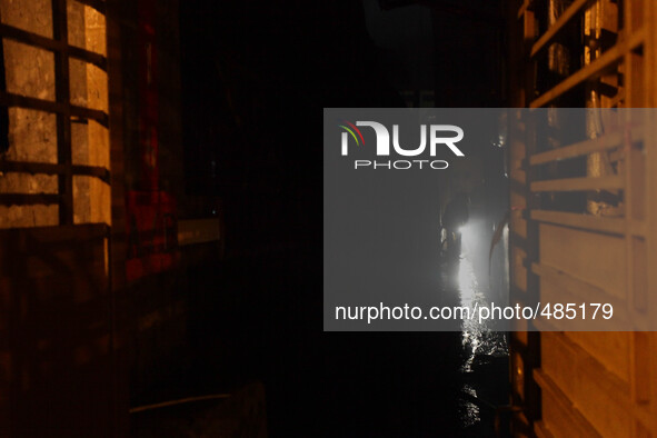 Makati City, Philippines - A Fireman examines the alley besides a house which caught fire in Barangay San Antonio, Makati City on Saturday e...