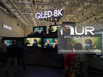 Visitors with the background of Qled 8K screens at Samsung boot during the international electronics and innovation fair IFA in Berlin on Se...
