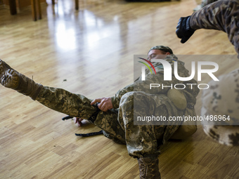 Volunteers and reserve soldiers are learning basics of first aid and using the combat application tourniquet at training center 'Patriot', K...