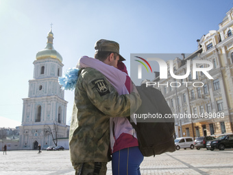 A volunteer of the OUN Battalion says his goodbyes during a ceremony before being sent to eastern Ukraine, near St. Sophia Cathedral in Kiev...