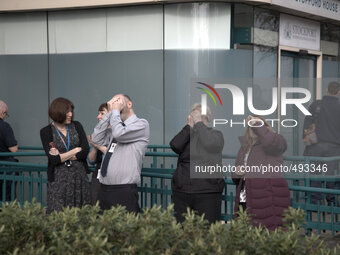 People watching the solar eclipse, when the moon obscured the sun for a short time, in central Stockport. (