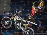 Brice Izzo, a French FMX rider, during his final jump in the opening day of Diverse NIGHT of the JUMPs in Krakow's Arena. Krakow, Poland. Fr...