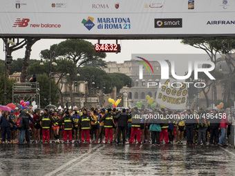 Runners take part of the 21th Marathon of Rome under heavy rain on March 22, 2015. (