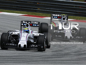 Brazilian Felipe Massa (L) of Williams Martini Racing and teamates, Finnish Valtteri Bottas competes during the Malaysian Formula One Grand...
