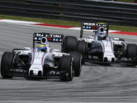 Brazilian Felipe Massa (L) of Williams Martini Racing and teamates, Finnish Valtteri Bottas competes during the Malaysian Formula One Grand...