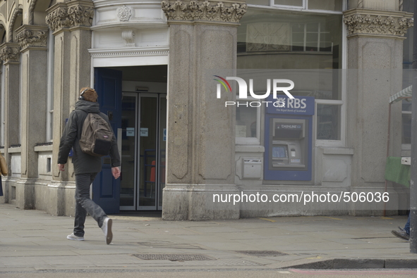 A person walks outside a branch of the Royal Bank of Scotland in Camden, London, on Friday 27th March 2015. 