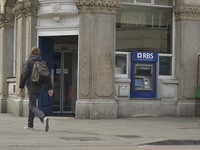 A person walks outside a branch of the Royal Bank of Scotland in Camden, London, on Friday 27th March 2015. (