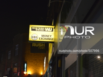 Light emitting from the sign of Western Union, in London, on Friday 27th March 2015. Western Union, based in the United States, is a multi-n...