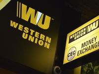 Light emitting from the sign of Western Union, in London, on Friday 27th March 2015. Western Union, based in the United States, is a multi-n...