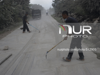 Residents clean dust-filled volcanic material Sinabung in rural villages after the latest eruption in Beganding village, Karo, Sumatra, Indo...