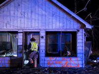 Emergency response personal searches a damaged house for survivors after a tornado struck the town of Fairdale, Illinois, United States on A...