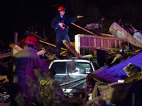 Emergency personal searches in the rubble for survivors after a tornado struck the town of Fairdale, Illinois, United States on April 9, 201...