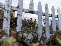 Emergency response crew examines the carnage left by a tornado passing by the evening before at the town of Fairdale, Illinois on Apr 10, 20...
