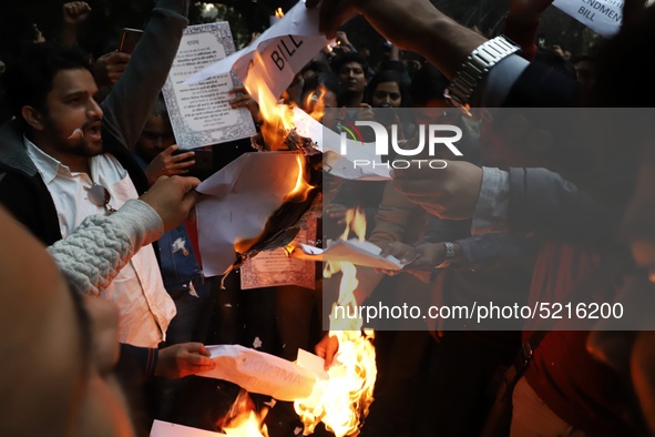 People burn a copy of a Citizenship Amendment Bill, passed by Indian Parliament on Monday, granting Indian citizenship to migrants of all of...