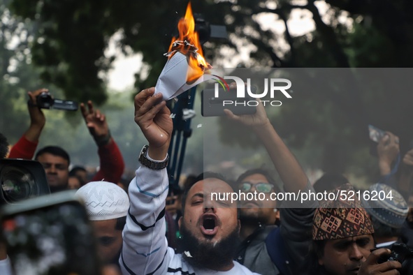 A Muslim man burns a copy of a Citizenship Amendment Bill, passed by Indian Parliament on Monday, granting Indian citizenship to migrants of...