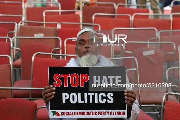 An elderly man holds a playcard during a protest against the citizenship amendment bill in New Delhi India on 10 December 2019.  