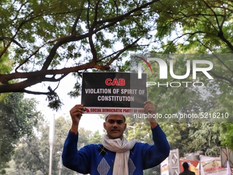 A boy holds a playcard during a protest against the citizenship amendment bill in New Delhi India on 10 December 2019.  (