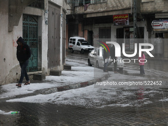 Palestinian Watching snow early this morning at Jabalia refugee camp northern the Gaza, heavy rain strikes the Gaza Strip since yesterday, A...