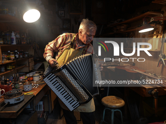 Former theatre actor and long time artist and luthier, Jozef Gmyrek (age 71), tunes an accordion in his workshop.     
His work is not a job...