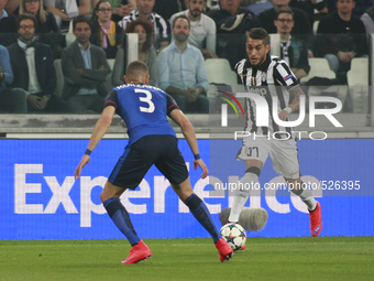 Roberto Pereyra and Layvin Kurzawa in action during the Champions Luague match between Juventus FC and AS Monaco at the Juventus Stafium of...