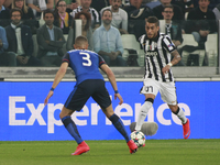 Roberto Pereyra and Layvin Kurzawa in action during the Champions Luague match between Juventus FC and AS Monaco at the Juventus Stafium of...