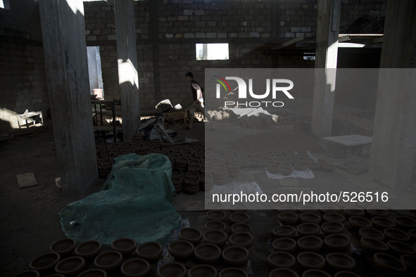 Young child working in a pottery factory in Gaza city, April 14, 2015. 