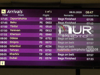 A screen displayed information on flights, including the one from Tehran marked as cancelled is seen at the Boryspil International Airport,...