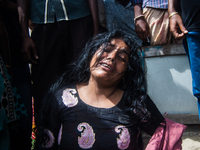 A women is crying at the Mawa Ferry Ghat on August 4, 2014 after her husband went missing when the Pinak-6 passenger vessel sank on the Padm...