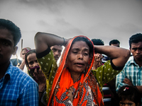 A mother anxiously waits to hear news about her missing son who disappeared when the MV Miraj - 4 capsized on the Meghna River near Munshigo...